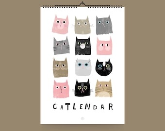 May include: A white calendar with a black border and a black spiral binding. The calendar features a design of 12 different cats with various colors and patterns. The text "CATLENDAR" is printed in black at the bottom of the calendar. The text "@studio.typealive" is printed in black at the bottom of the calendar.