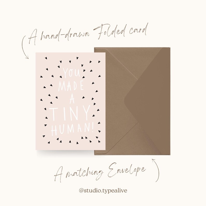May include: A pink folded card with black hearts and the text "You made a tiny human!"  A brown envelope is included.