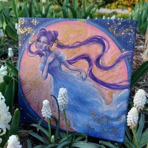May include: A painting on canvas of a woman with long purple hair, wearing a blue dress, standing in front of a pink and gold moon. The background is a dark blue with gold stars.