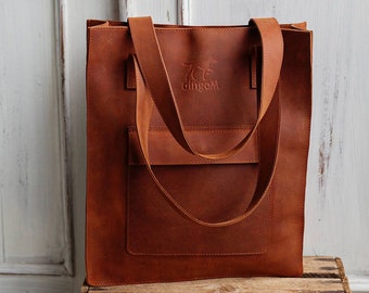 Brown leather tote bag with the crossbody strap