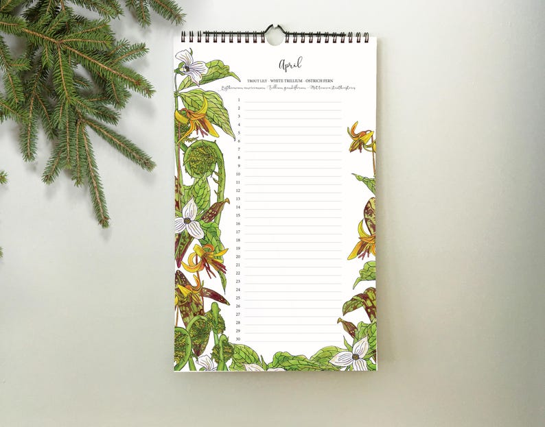 May include: A spiral-bound calendar for April, featuring botanical illustrations of wildflowers in shades of yellow, white, and green. The word "April" is written in cursive at the top. The calendar has lined spaces for daily entries.