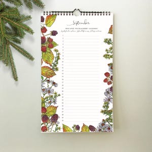 May include: A spiral-bound calendar for September, featuring a white background with a floral and berry border. The calendar has a list format with lines for each day. The top of the calendar reads "September" in cursive.