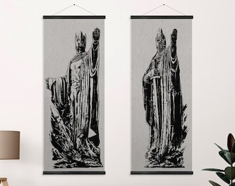 May include: Two black and white wall tapestries featuring a stylized illustration of a king in a crown and robe. The king is holding a sword in one hand and his other hand is raised in the air. The tapestries are hanging on a white wall.