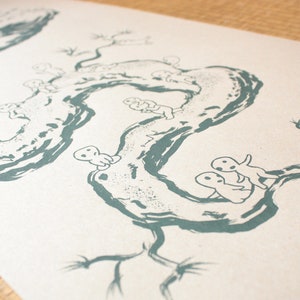 May include: A print featuring a teal illustration of a winding tree branch with small, white, humanoid figures. The artwork has a minimalist style, with a focus on the organic shapes and forms. The background is a light beige.