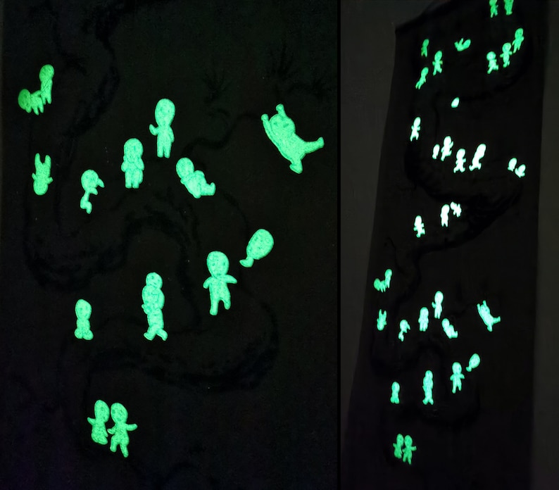 May include: Two dark panels with a black background, featuring glowing green figures. The figures are in various poses, resembling people and animals. The figures are scattered across the panels, creating a whimsical and artistic display.