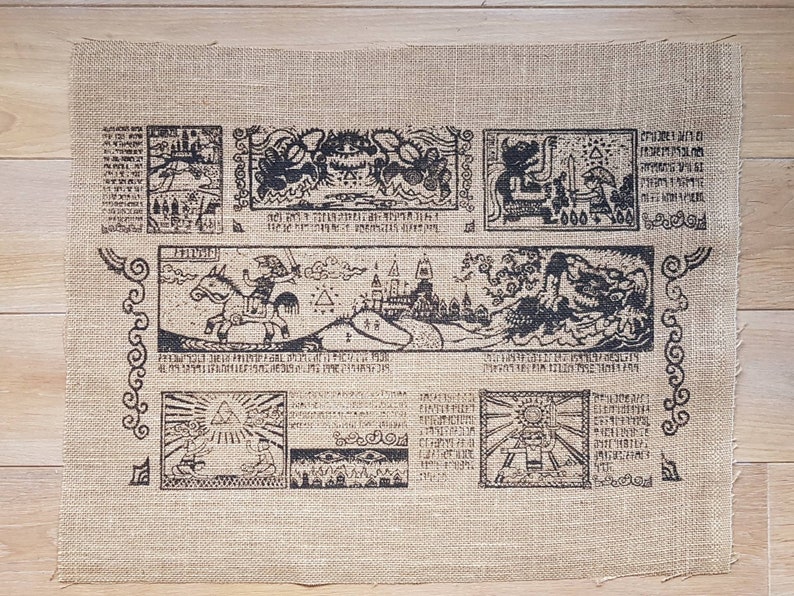 May include: A brown burlap fabric with a black and white printed design. The design features a map with various symbols and text, including "The Legend of Zelda" and "Triforce".