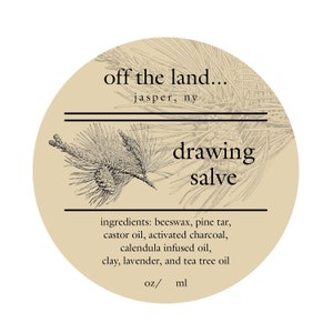 May include: A round label with the text "off the land..." and "drawing salve." The label includes a botanical illustration of a pine branch and cone. Ingredients listed include beeswax, pine tar, and tea tree oil.