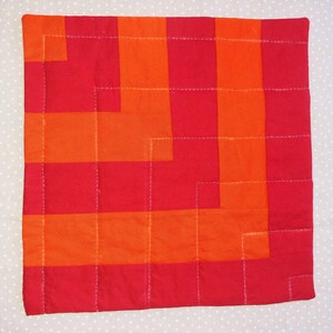 Amish-inspired, hand-quilted table pads in bright, cheerful solids