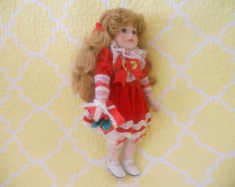 Vintage Collectible Doll Jolie with Christmas present in hand. 14.5''Tall Made in Taiwan. Art Doll. Copyright MANN 1989.