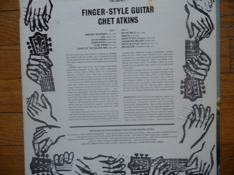 May include: A vintage record album cover featuring a black and white illustration of hands playing a guitar. The album is titled "Finger-Style Guitar Chet Atkins" and lists the songs on each side of the record.