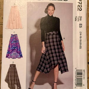 May include: McCall's sewing pattern MP722, size E5, featuring skirt designs. The pattern includes a photo of a woman wearing a plaid skirt. The packaging has the text "She believed she could... sew she did."