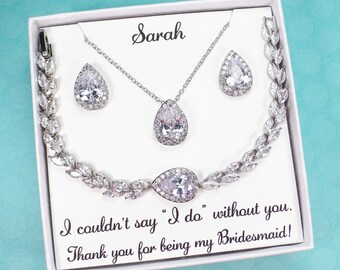 May include: A white gift box with a silver necklace, earrings, and bracelet. The box has a card that says "Sarah" and "I couldn't say "I do" without you. Thank you for being my Bridesmaid!"