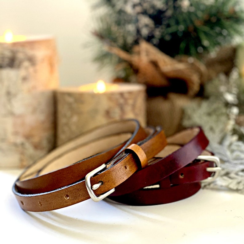 Photo of the tan and reddish brown leather belt options. The inside of the belt is undyed natural tan suede.