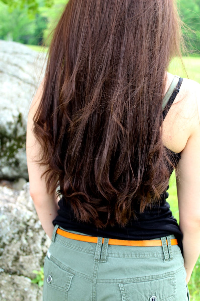 Model wearing the tan leather belt shown from the back.