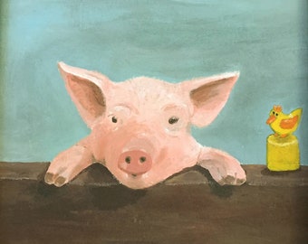 May include: A pink piglet with a long snout peeks over a brown wooden surface. A yellow toy chick with orange beak and feet sits on a yellow base to the right of the piglet.