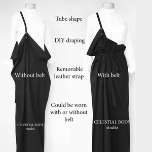 May include: Two mannequins wearing a black tube-shaped dress with a removable leather strap. The dress can be worn with or without a belt. The dress is labeled "CELESTIAL BODY studio".