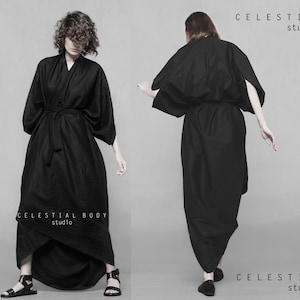 May include: Two models wearing long black robes with a wrap style closure. The robes are made of a soft, flowing fabric. The text "CELESTIAL BODY studio" is visible at the top and bottom of the image.