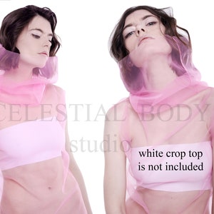 May include: A pink sheer top with a high neck and a loose fit. The top is made of a lightweight fabric and has a flowing silhouette. The text "white crop top is not included" is printed on the front of the top.