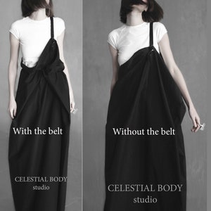 May include: A black linen dress with a single strap. The dress is shown with and without a belt. The text "With the belt" and "Without the belt" is shown below the images. The text "CELESTIAL BODY studio" is shown below the images.