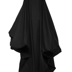 Puede incluir: Un vestido negro, sin tirantes, largo hasta el suelo, con una falda amplia y voluminosa y tirantes ajustables.