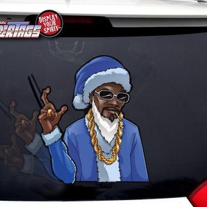 May include: A blue and white cartoon image of a man wearing a Santa hat, sunglasses, and a gold chain. The man is smoking a cigarette. The image is a car decal with the text "THE ORIGINAL WIPERTAGS" and "DISPLAY YOUR SPIRIT".