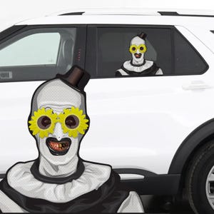 May include: A white car with a window decal of a clown with yellow sunflower glasses and a black top hat. The clown has a white face, black lips, and a black and white collar. The decal is on the car window.