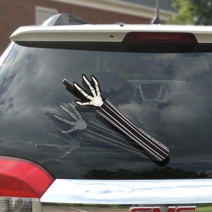Waving Skellington Arm WiperTags.  Universal size attaches securely to rear wiper of minivans, SUVs, cars.