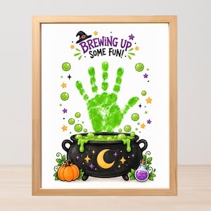 May include: A framed print featuring a black cauldron with a green handprint rising from it, surrounded by green bubbles, stars, and a pumpkin. The text reads BREWING UP SOME FUN! with a witch hat icon above the text and a small purple potion bottle.