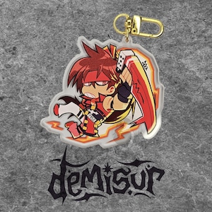 May include: An acrylic keychain featuring a stylized anime character with spiky brown hair, a red headband, and a red outfit, holding a large red blade. The character has the word FREE printed on their chest. It includes a gold-colored metal clasp.