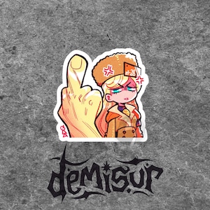 May include: A sticker featuring a cartoon illustration of a blonde person wearing a fur hat and a brown coat, giving the middle finger. The sticker has the text "Demisur" in a stylized font at the bottom.