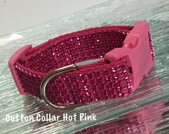 May include: A hot pink dog collar with a sparkly finish and a silver buckle.  Cotton Collar Hot Pink.