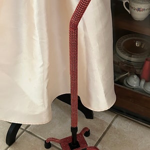 Red bling Quad Cane folds for easy traveling, handmade. Four foot metal base. Will last for years. Sturdy and elegant. Great gift!