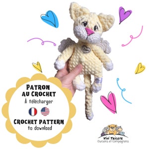 May include: Crochet pattern for a yellow and white angel cat amigurumi toy. The pattern is available for download in both French and English. The image shows the finished toy with a heart-shaped tag that says "Elise".