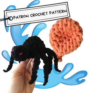 May include: A black crocheted spider with red eyes, a crocheted orange brain, and a sign that says "OPATRON CROCHET PATTERN".