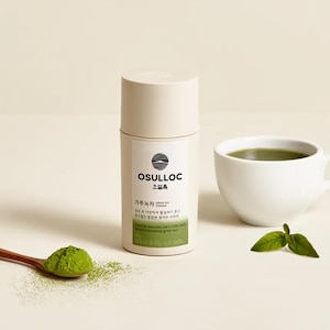 May include: A cylindrical container of OSULLOC green tea powder with text and a logo, a white teacup filled with green tea, a wooden spoon with green tea powder, and a few green leaves. The container is beige and white.