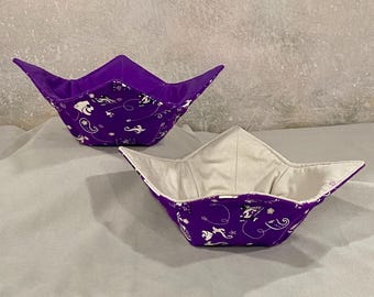 May include: Two purple fabric bowls with a white paisley pattern. The bowls are folded flat and are ready to be used.