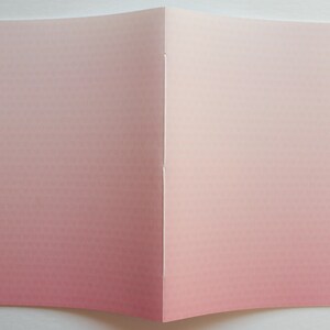 May include: A folded card with a pink to white ombre gradient. The card is blank and ready for writing.