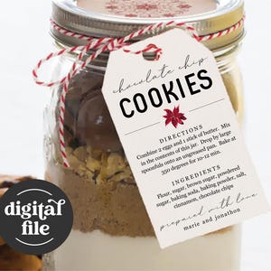 May include: A clear glass jar filled with cookie ingredients, including chocolate chips, flour, and sugar. A tag reads "chocolate chip COOKIES" with baking instructions and ingredients. A baked cookie is in the foreground. The words "digital file" are on a black circle.