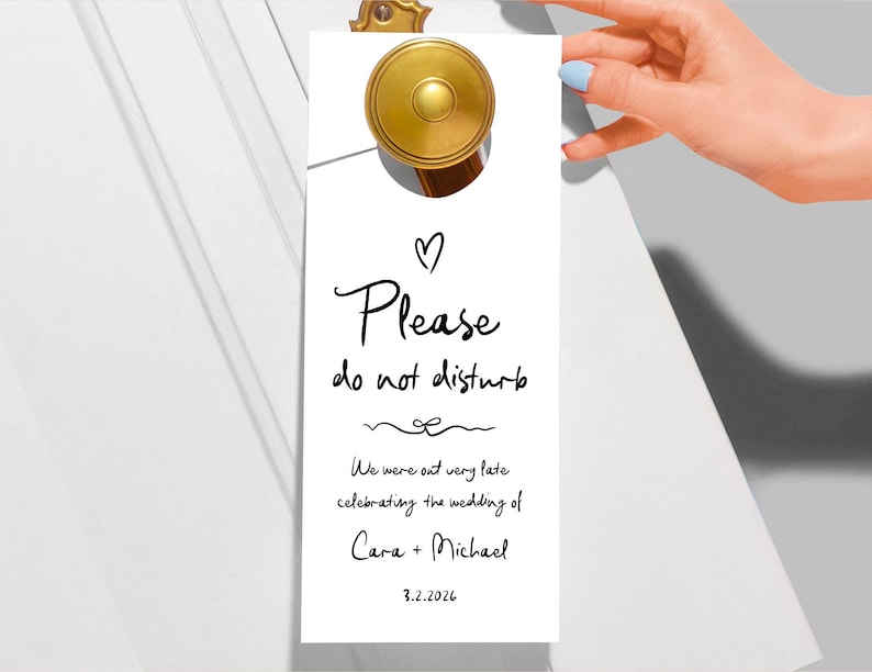 May include: White door hanger with black text that reads "Please do not disturb. We were out very late celebrating the wedding of Cara + Michael 3.2.2026".
