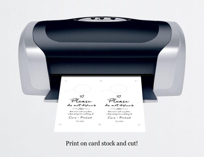 May include: Two white cards with black text that reads "Please do not disturb" with a heart symbol above the text. The text also includes the names "Cara & Michael" and the date "8.5.2023". The cards are being printed on a black and silver printer. The text at the bottom of the image reads "Print on card stock and cut!"