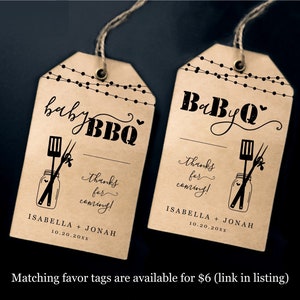 May include: Two brown paper tags with a string attached. The tags have a black and white illustration of a mason jar with a spatula and tongs inside. The text on the tags reads "baby BBQ" and "thanks for coming!" with the names "Isabella + Jonah" and the date "10.20.20xx".