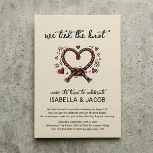 May include: A cream-coloured invitation card featuring the text "we tied the knot" and "now it's time to celebrate ISABELLA & JACOB". A central illustration shows a brown rope tied into a heart shape, surrounded by small red hearts and yellow stars.