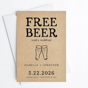May include: A wedding invitation card with the text "FREE BEER (and a wedding)" in black. The card is tan with a white envelope. The names Isabella and Jonathon, and the date 5.22.2026 are also printed on the card.