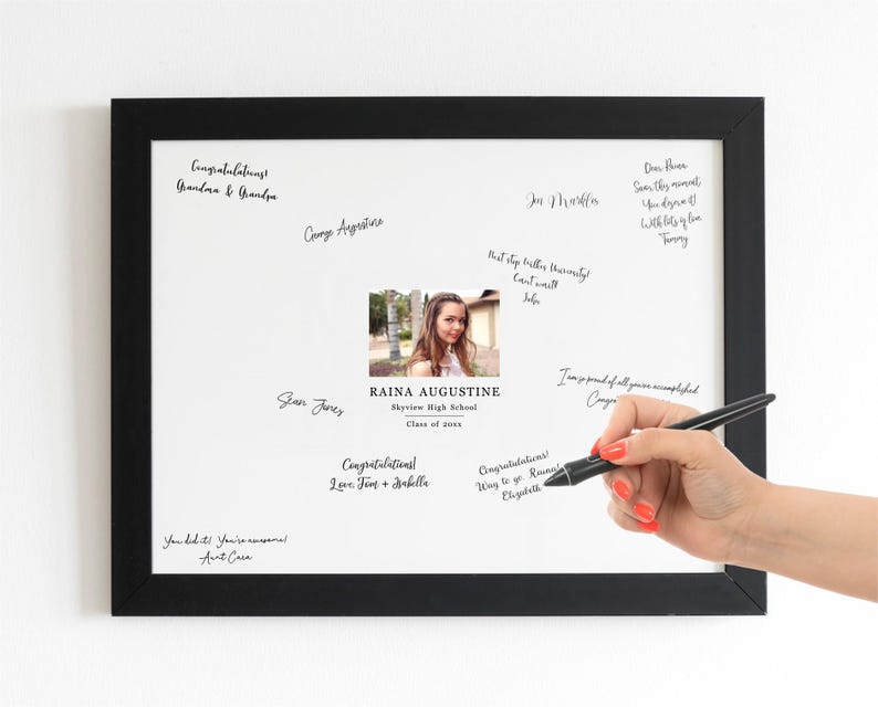 May include: A white framed board with a black border, featuring a photo of a young woman and handwritten messages. The text includes "Congratulations Raina Augustine, Skyview High School, Class of 2024".