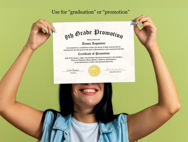 May include: A white certificate with a gold seal, reading "5th Grade Promotion" and "Certificate of Promotion". The certificate is being held up by a person, covering their face.