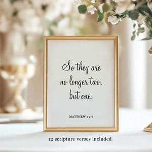 May include: A vertical rectangular gold frame containing a white print with black text that reads: So they are no longer two, but one. MATTHEW 19:6. Below the frame, the text 12 scripture verses included is printed on the white surface.