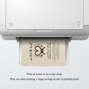 May include: A white printer outputting a cream-coloured wedding invitation card featuring a brown rope tied into a heart shape, red heart accents, and black text that reads we tied the knot, now it's time to celebrate, ISABELLA & JACOB.