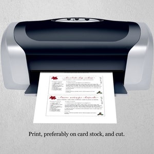 May include: A black and silver printer printing two recipe cards. The cards feature text and decorative elements in red. The bottom of the image has the text: "Print, preferably on card stock, and cut."