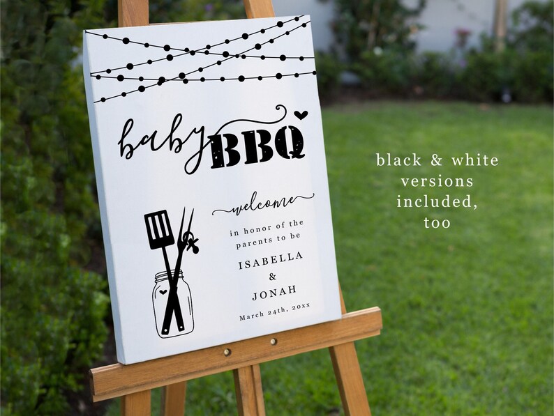 May include: A white sign with black text and graphics announcing a "baby BBQ" in honor of the parents to be, Isabella and Jonah. The sign features a string of lights, a jar with a spatula and tongs, and the date March 24th, 20xx.