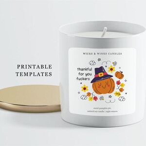 May include: A white candle with a gold lid, featuring a label with a cartoon pumpkin wearing a hat and the text "thankful for you fuckers." The candle is labeled "sweet pumpkin pie" and is 8 ounces.